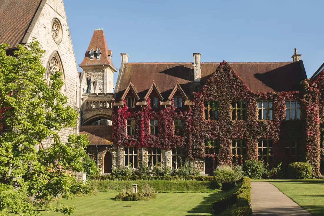 Ivy-covered school building with lawn in the foreground