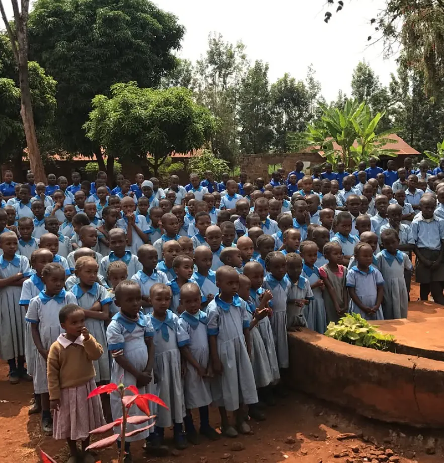 Rows of schoolchildren in blue uniforms at a school in Kenya