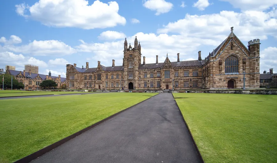 A historic university quad with a wide lawn